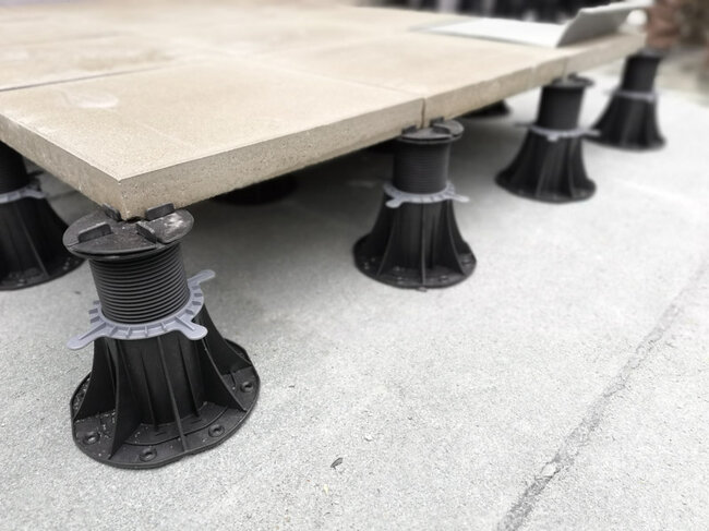 close up of adjustable plastic pedestal supports elevating o