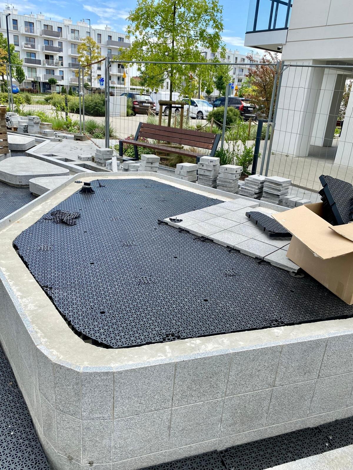 DeckSafe raised pedestal system supporting interlocking drainage subfloor tiles and patio pavers.